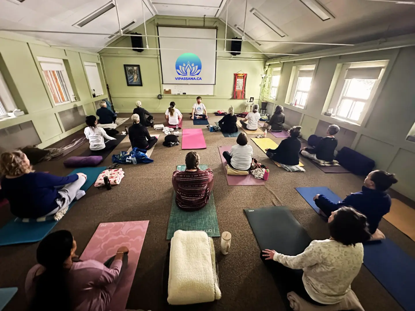 3-day Vipassana retreat in Alberta: participants meditating on mats in the meditation hall