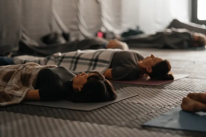 Yoga nidra at a Vipassana.ca event in Alberta: participants lying under blankets on mats with eyes closed