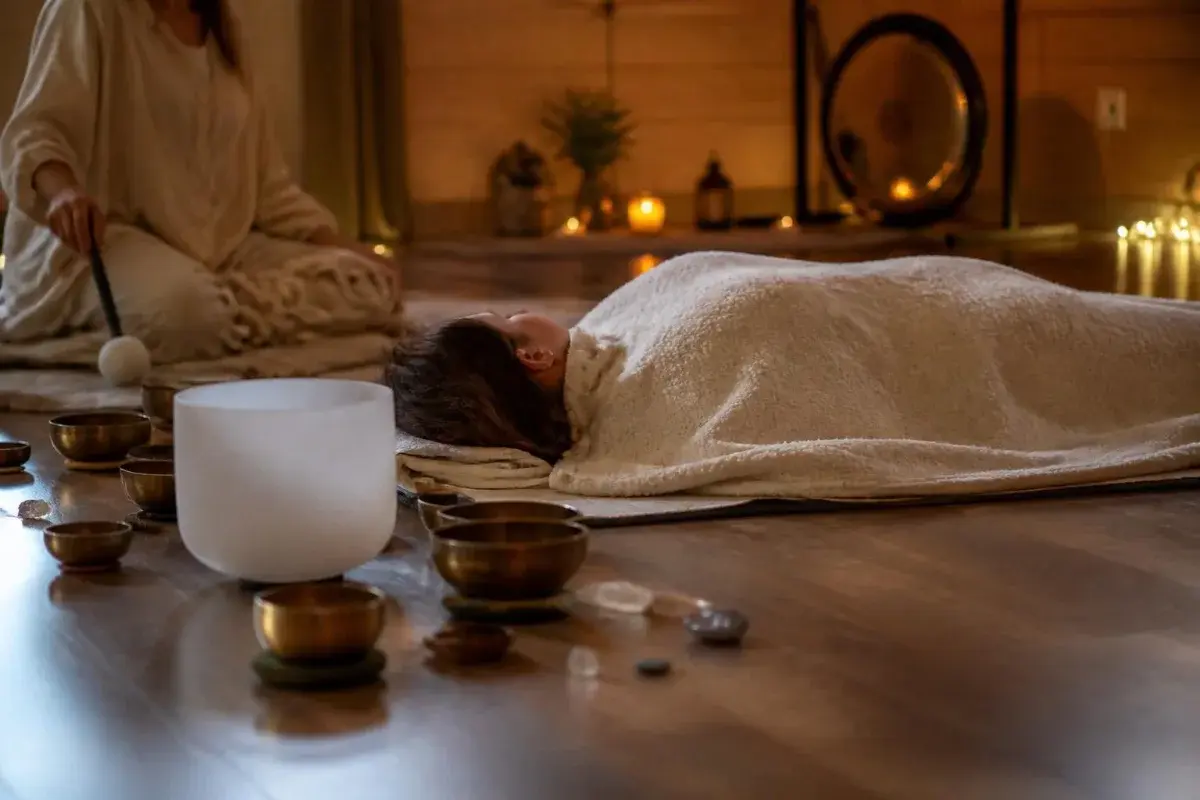 Sound bath meditation: lying under a blanket listening to crystal and Tibetan singing bowls